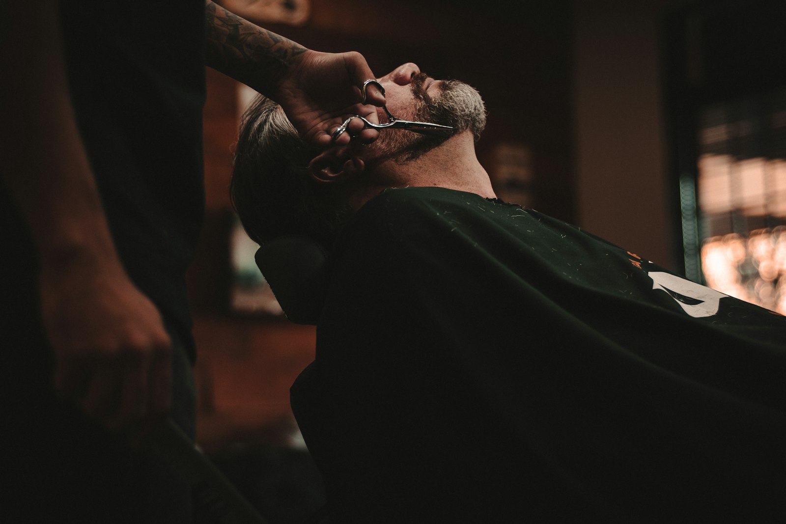 Barber working a fade in a busy barbershop
