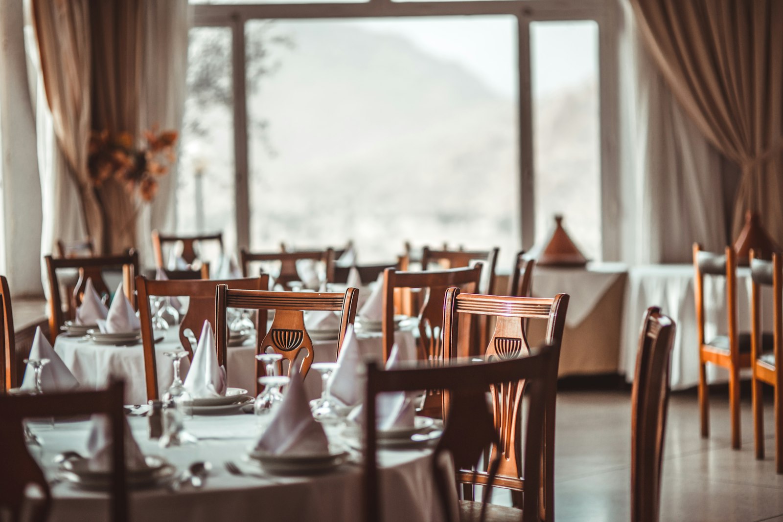 Warm restaurant dining room set for evening service